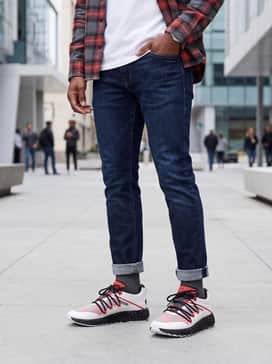 Combine them with slim-fit dark wash denim, a crisp white tee, and an unbuttoned red flannel shirt to highlight the sneaker's accent colors.