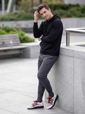Go for an athletic look with charcoal grey tapered joggers and a black performance hoodie for a cohesive, high-energy gym-to-street outfit.