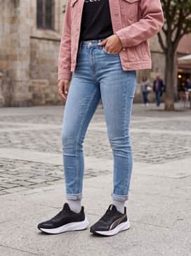 Light-wash skinny jeans, a tucked-in black graphic tee, and a dusty pink denim jacket to complement the shoe's metallic accents.