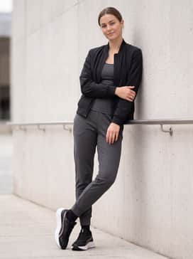 Pounce Lite – Tapered charcoal joggers with a fitted technical tank top and a sleek black bomber jacket for a modern, sporty urban aesthetic.