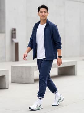 A navy blue performance tracksuit with a crisp white t-shirt to emphasize the dark accents of the sole and the ASICS stripes.