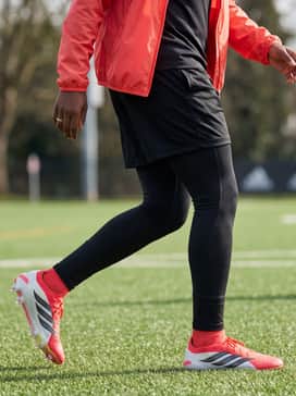 Predator Elite Artificial Ground Soccer Cleats – Full Team Warm-up: Layer a lightweight windbreaker in a matching pink or red shade over a standard black team tee. Pair with black athletic leggings under loose-fitting mesh shorts to stay warm while showcasing the boots' aggressive design during pre-game drills.