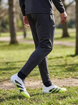 Predator Elite Firm Ground Cleats – A full team tracksuit in monochromatic charcoal or black to allow the Solar Yellow accents on the cleats to stand out during pre-match warm-ups.