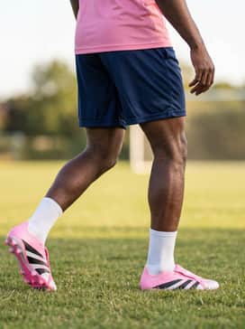 Predator League Foldover Tongue Firm Groundmulti Ground Football Boots Beckham – Summer Practice: Breathable mesh shorts in dark navy and a moisture-wicking pink training tank to create a cohesive, high-energy monochromatic sports aesthetic.