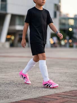 Predator League Foldover Tongue Firm Groundmulti Ground Football Boots Kids Beckham – Match Day Professional: A coordinated team kit featuring a black moisture-wicking jersey, matching black athletic shorts, and knee-high white performance socks that let the pink boots serve as a vibrant focal point.