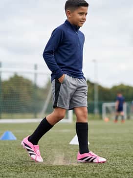 Predator League Foldover Tongue Firm Groundmulti Ground Football Boots Kids Beckham – Technical Training Look: A sleek navy blue quarter-zip training top paired with breathable grey mesh shorts and black crew-length sports socks for a professional, focused aesthetic on the field.