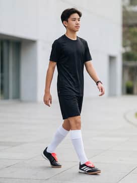Predator League Foldover Tongue Indoor Soccer Shoes Kids – A complete team kit with a black moisture-wicking jersey, matching athletic shorts, and high-performance white soccer socks.