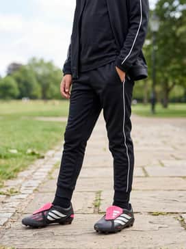 Predator League Foldover Tongue Artificial Ground Soccer Boots Kids – a sleek black adidas tiro tracksuit with white side-piping for a professional-looking warmup ensemble.