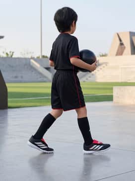 A full team soccer kit featuring black shorts, high-performance socks, and a matching red moisture-wicking jersey for a professional look on the field.