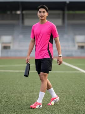 Predator Pro Foldover Tongue Artificial Ground Soccer Cleats – A matching high-performance solar pink jersey paired with black compression shorts and white moisture-wicking soccer socks pulled up to the knee.