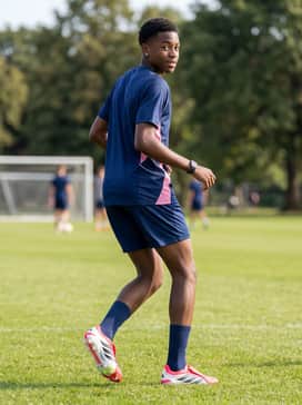 Predator Pro Foldover Tongue Artificial Ground Soccer Cleats – Team-branded training gear featuring a primary navy blue kit with pink side panels to complement the vibrant hue of the cleats.