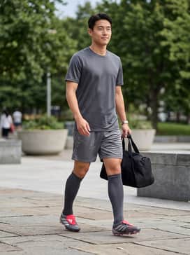 Predator Pro Foldover Tongue Firm Ground Soccer Boots – A full team match kit featuring a charcoal grey performance jersey, matching breathable shorts, and high compression socks pulled up to the knee to highlight the boot silhouette.
