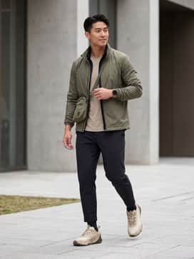 Project Rock 8 – A performance-focused look with black tapered joggers, a matching moisture-wicking compression tee, and a lightweight olive green windbreaker for outdoor warmups.