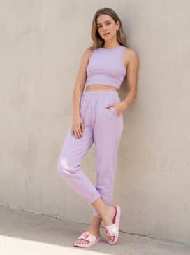 Puma X Care Bears X Sesame Street Cool Cat Womens Slides – Soft lavender sweatpants and a matching cropped tank top for a whimsical and comfortable 'athleisure' look.
