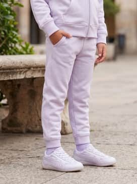 Matching pastel purple joggers and a zip-up hoodie set for a comfortable and coordinated sporty-chic aesthetic perfect for travel or play.