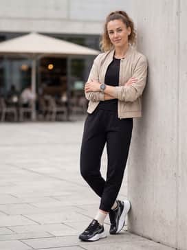 Sleek athleisure: Wear with tapered black joggers, a white ribbed crop top, and a lightweight nylon bomber jacket in a neutral sand color for a balanced, modern look.