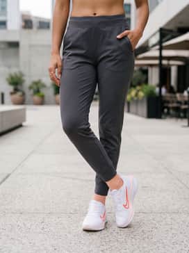 Quest 6 – Charcoal grey tapered joggers with a cropped white oversized hoodie and a peach-toned baseball cap for a coordinated weekend errand look.