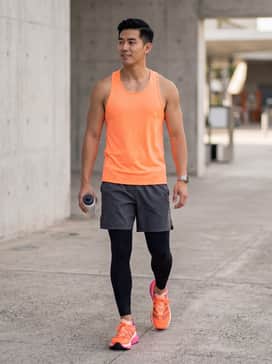 Performance Ready: Pair with black compression tights, charcoal grey athletic shorts, and a moisture-wicking neon orange racerback tank to echo the shoe's primary hue.