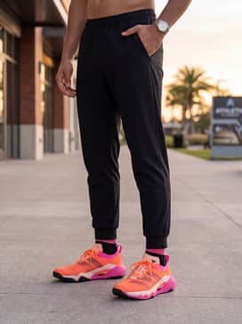 Rapidmove Pro Training Shoes – Urban Edge: Style with tapered black joggers, a white oversized graphic t-shirt featuring pink accents, and a lightweight black bomber jacket for a sleek streetwear look.