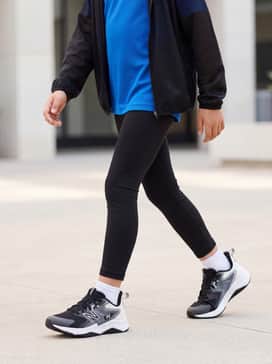 A sporty look featuring black compression leggings, a vibrant cobalt blue moisture-wicking jersey, and a lightweight mesh running jacket for track practice.