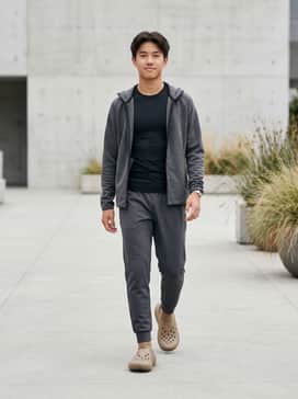 Pair with charcoal grey tapered joggers, a black moisture-wicking compression top, and a lightweight tech-fleece zip-up for a streamlined athletic recovery look.