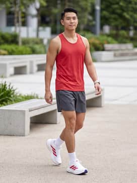 Pair with charcoal grey technical running shorts, a moisture-wicking red tank top, and high-performance no-show socks for a dedicated athletic look.