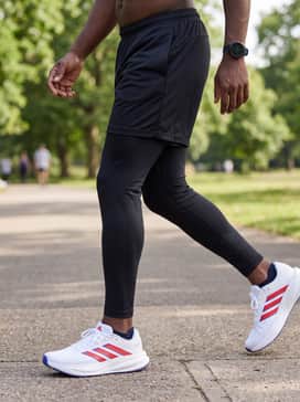 Match with black compression leggings, a white seamless long-sleeve performance shirt, and a sport watch for a high-tech training ensemble.