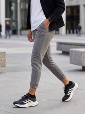 Response 2 Running Shoes – An effortless weekend look featuring tapered grey joggers, a tucked-in oversized white tee, and a black denim jacket for a layered aesthetic.
