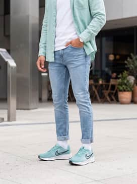 A clean weekend ensemble with slim-fit light-wash denim, a crisp white organic cotton tee, and an unbuttoned mint green linen shirt to tie in the shoe color.