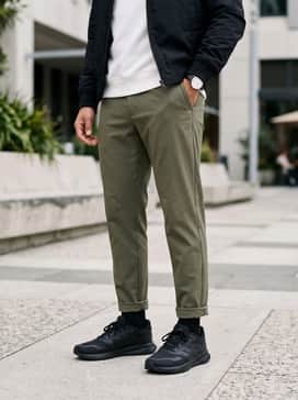 Runfalcon 5 Wide Running Shoes – Casual athleisure ensemble with tapered olive green joggers, a crisp white crewneck sweatshirt, and a lightweight black nylon bomber jacket.