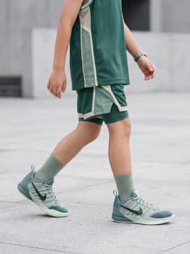 A matching forest green mesh basketball jersey and performance shorts set for a cohesive, professional on-court look.