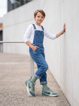 Sabrina 3 – Classic blue denim overalls worn over a crisp white long-sleeve tee for a playful, streetwear-inspired weekend outfit.