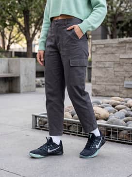 Sabrina 3 Morale – A high-fashion streetwear ensemble with oversized charcoal utility cargo pants and a cropped mint green graphic hoodie.