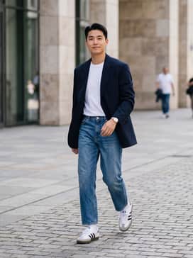 Samba Decon Shoes – Straight-leg blue jeans, a white crew-neck t-shirt, and an oversized navy blazer for a classic smart-casual look.