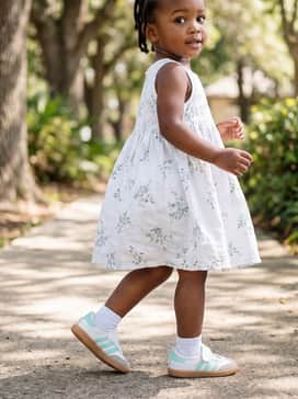 A lightweight white sundress featuring a delicate seafoam green floral print for a coordinated and breezy summer aesthetic.