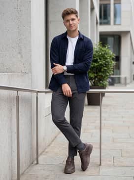 Samba Lx Freizeit – Charcoal grey tailored chinos worn with a tucked-in white t-shirt and an unbuttoned navy blue flannel overshirt for a polished yet relaxed weekend ensemble.
