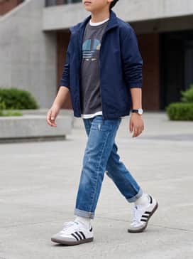 Pair with straight-leg blue jeans, a vintage-style graphic t-shirt, and a lightweight navy blue windbreaker for a timeless school-day look.