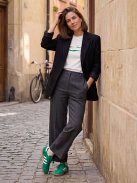 Samba Og Shoes – Charcoal grey wide-leg trousers styled with a tucked-in white graphic tee and a structured black blazer for a high-low 'smart casual' look that lets the shoes pop.