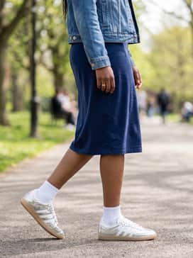 Samba Shoes – A simple navy blue t-shirt dress layered with a classic denim jacket for an effortless weekend look where the metallic shoes act as the statement piece.