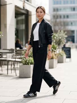 Samba Shoes – Oversized wide-leg black trousers paired with a tucked-in white baby tee and a cropped faux-leather bomber jacket for a modern silhouette.