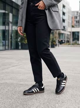 Samba Shoes – High-waisted straight-leg light wash jeans with a black turtleneck bodysuit and an oversized grey wool blazer.