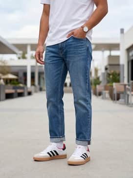 Samba Xlg Shoes – Mid-wash straight-leg jeans with a white graphic t-shirt and a red baseball cap to pull out the subtle red accent in the shoe's collar.