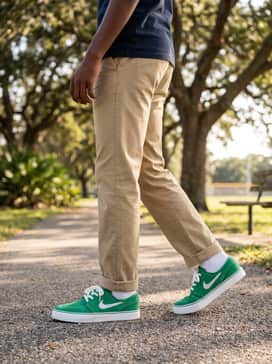 Sb Stefan Janoski – Classic khaki chinos rolled slightly at the ankle worn with a navy blue polo shirt for a clean, preppy-casual look that still feels youthful.