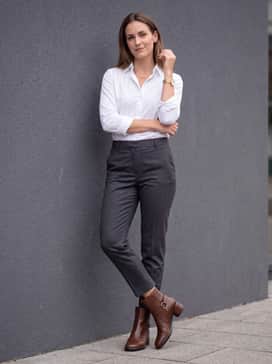 Sculpted Lx 35 – Charcoal grey tapered trousers that hit just above the boot shaft, combined with a crisp white button-down and gold statement jewelry to echo the hardware.