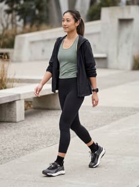 Seasons Voyage Nitro 3 Womens Trail Running Shoes – Black high-waisted compression leggings paired with a sage green moisture-wicking racerback tank and a lightweight black windbreaker.