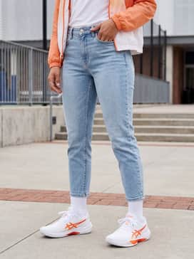 For a trendy off-court vibe, pair these with light-wash tapered denim jeans, a cropped white graphic tee, and an oversized orange zip-up hoodie.
