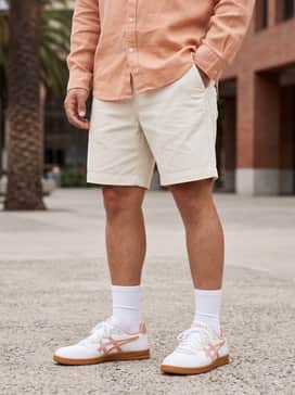 Skyhand Og – Cream-colored chino shorts matched with a peach-toned linen button-down shirt and white crew socks to highlight the shoe's accent colors.