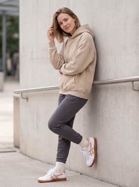 Tapered charcoal joggers and an oversized sand-colored hoodie for a comfortable, modern streetwear aesthetic.