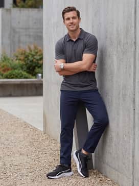 Skyrocket Lite 2 – Outdoor Utility: Charcoal cargo shorts worn with a forest green moisture-wicking polo and a technical baseball cap, perfect for a day of errands or park walks.
