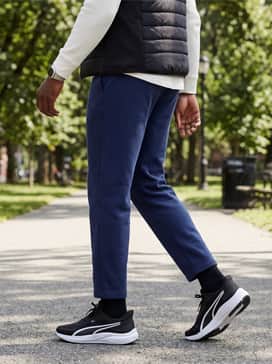 Skyrocket Lite 2 – Modern Athleisure: Navy blue sweatpants with a cuffed hem, a black quilted vest over a long-sleeve white waffle-knit top for a layered, comfortable transition outfit.